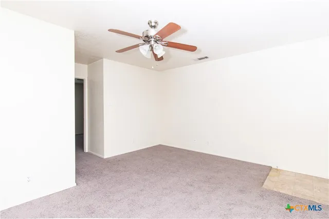 a view of a room with cabinet and fan