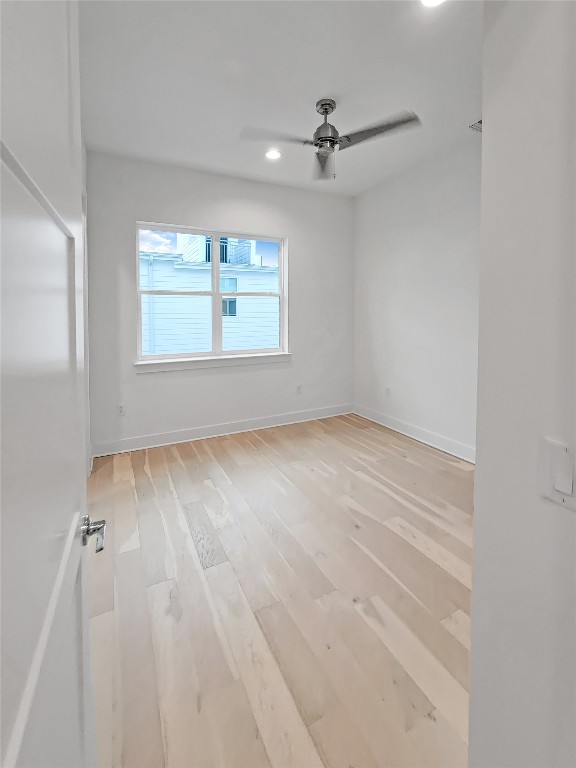 3807 Threadgill Street Austin, TX 78723 - Photo 14 of 36 an empty room with wooden floor fan and windows