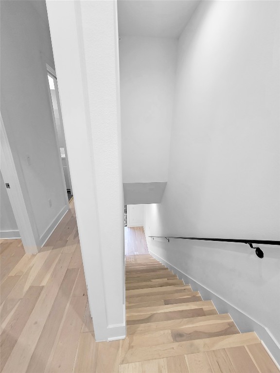 3807 Threadgill Street Austin, TX 78723 - Photo 22 of 36 a view of a hallway with wooden floor and staircase