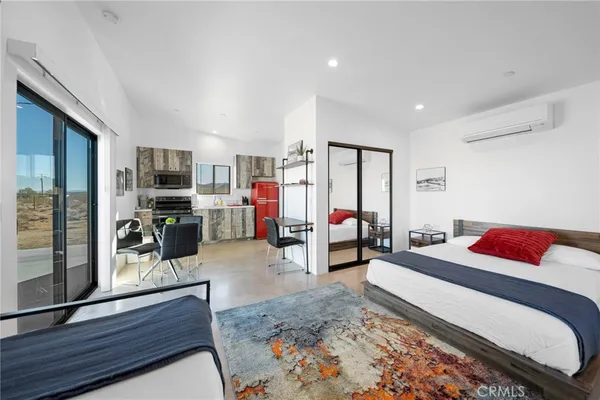 a bedroom with furniture and a flat screen tv
