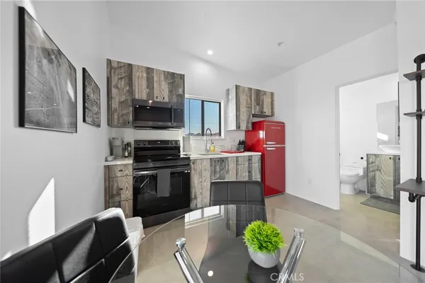 a kitchen with stainless steel appliances kitchen island granite countertop a refrigerator and a stove