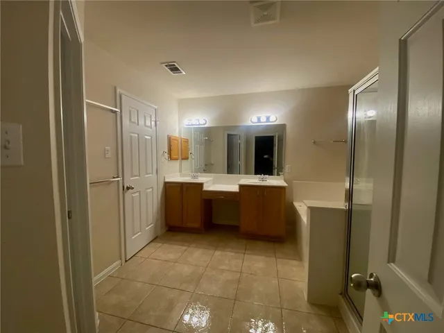 a large bathroom with a large tub and sink