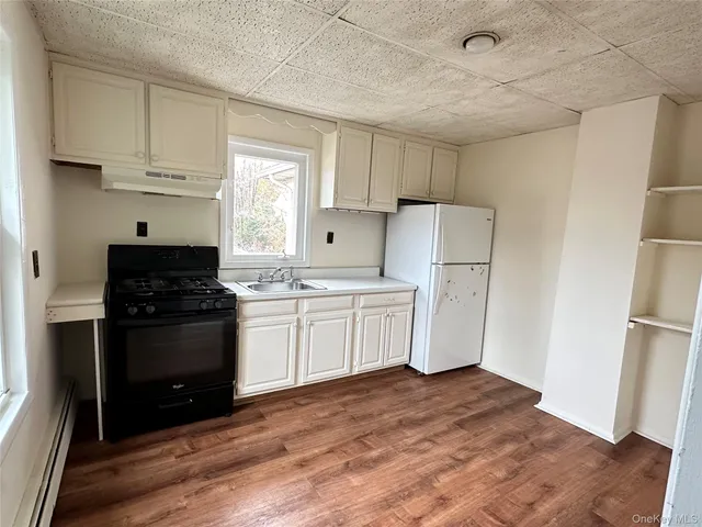 a kitchen with a refrigerator a stove a microwave and cabinets