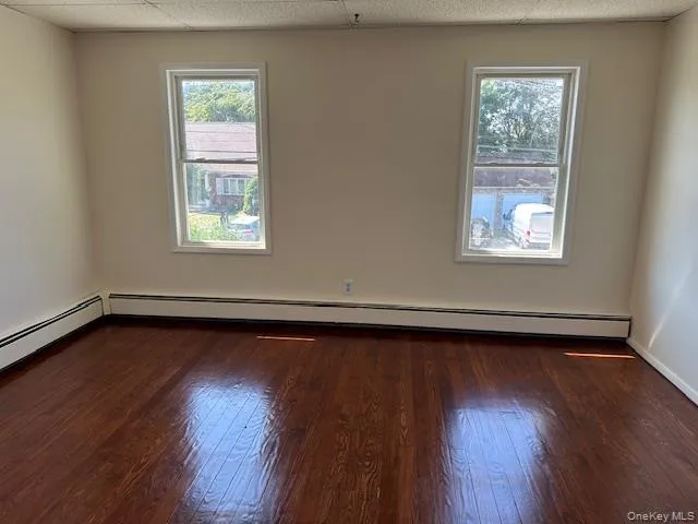 a view of a room with wooden floor and window