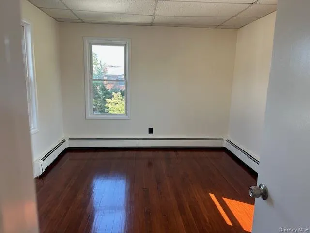 a view of a room with wooden floors and window