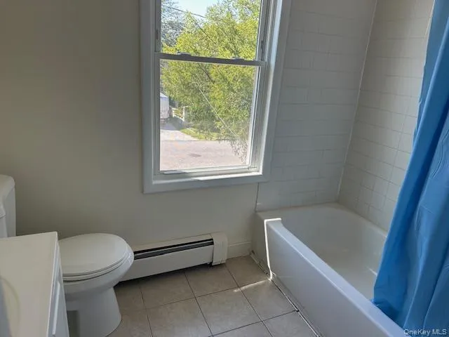 a bathroom with a toilet bathtub and window