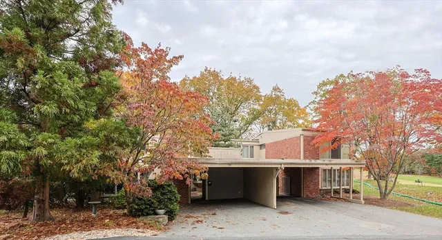 a view of a house with a large tree and a big yard