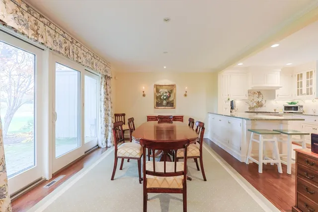 a view of a dining room with furniture and a large window
