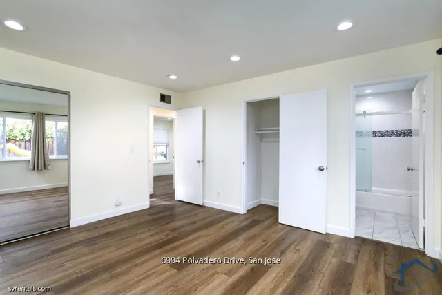 a view of hallway with wooden floor