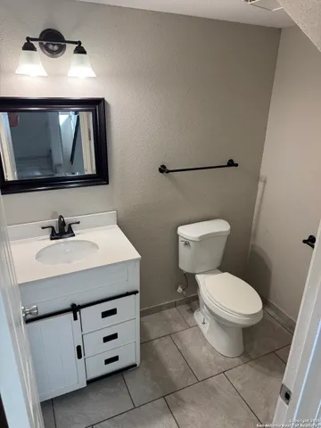 a bathroom with a sink toilet and mirror