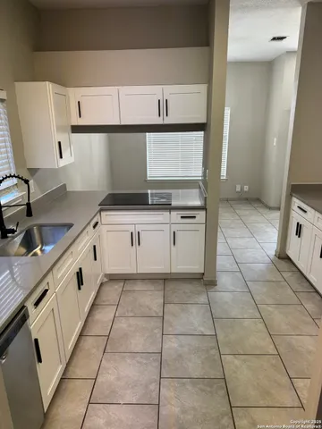a kitchen with cabinets and appliances