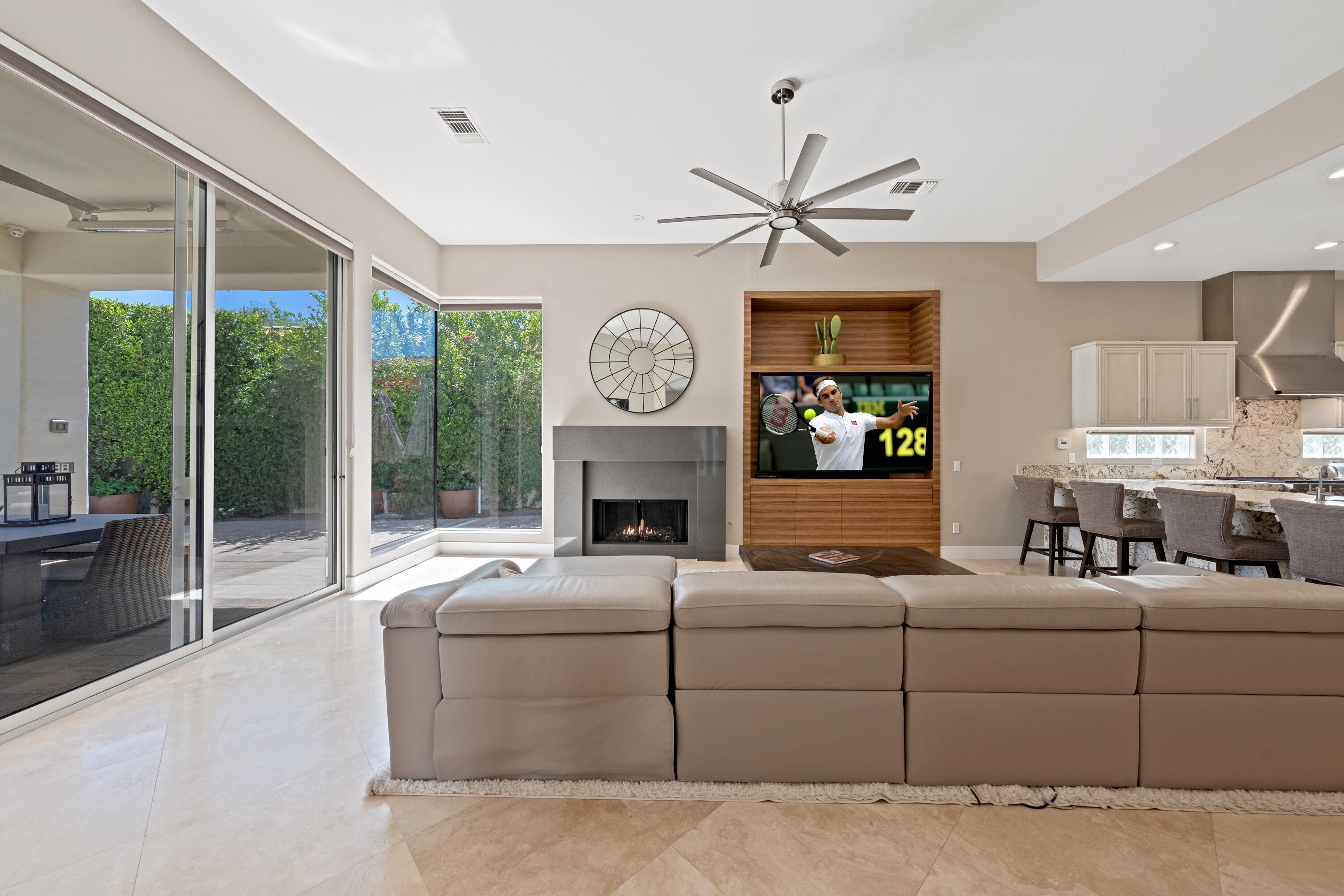306 Loch Lomond Road Rancho Mirage, CA 92270 - Photo 12 of 60 a living room with furniture a large window and a fireplace