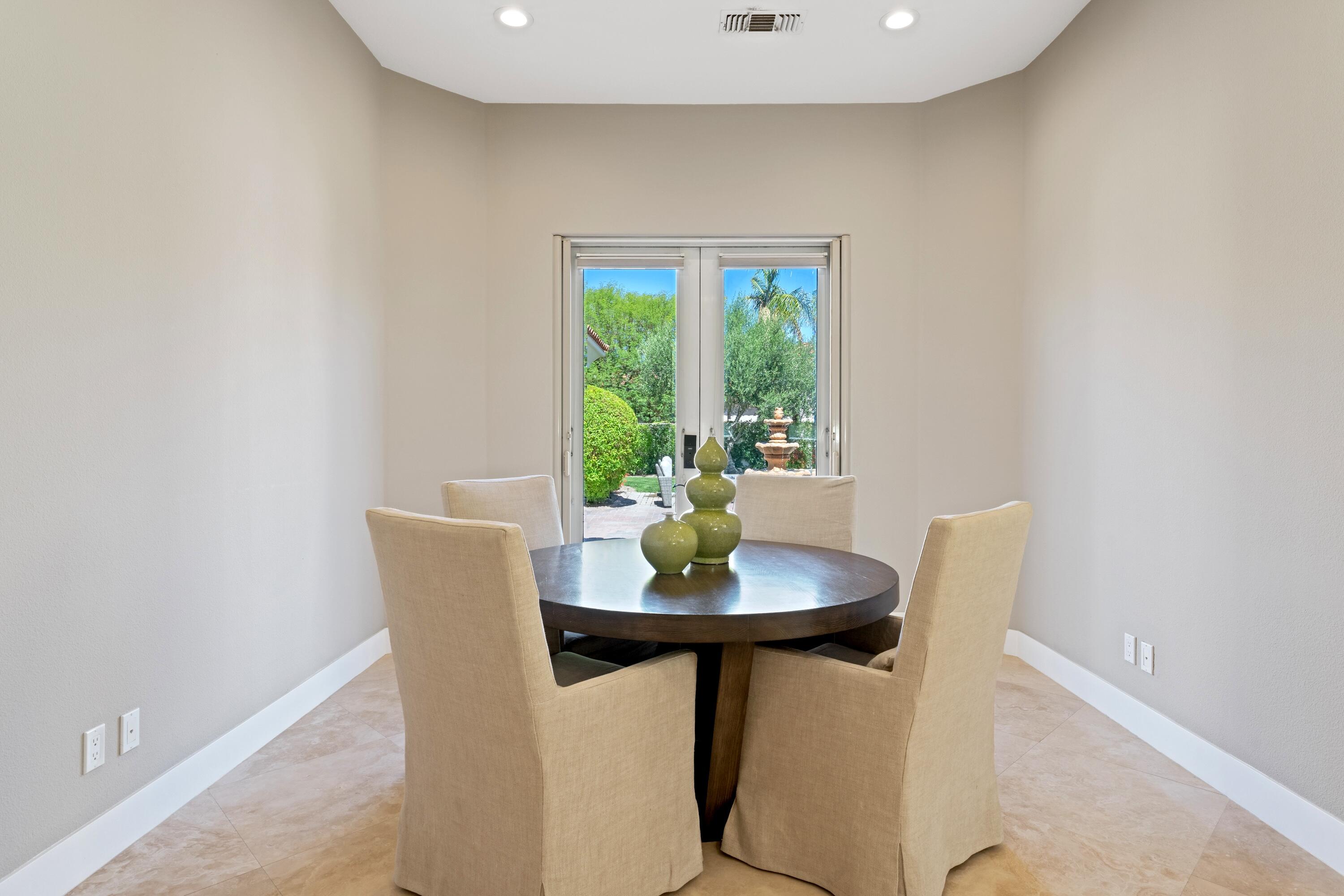 306 Loch Lomond Road Rancho Mirage, CA 92270 - Photo 22 of 60 a dining room with furniture and a potted plant
