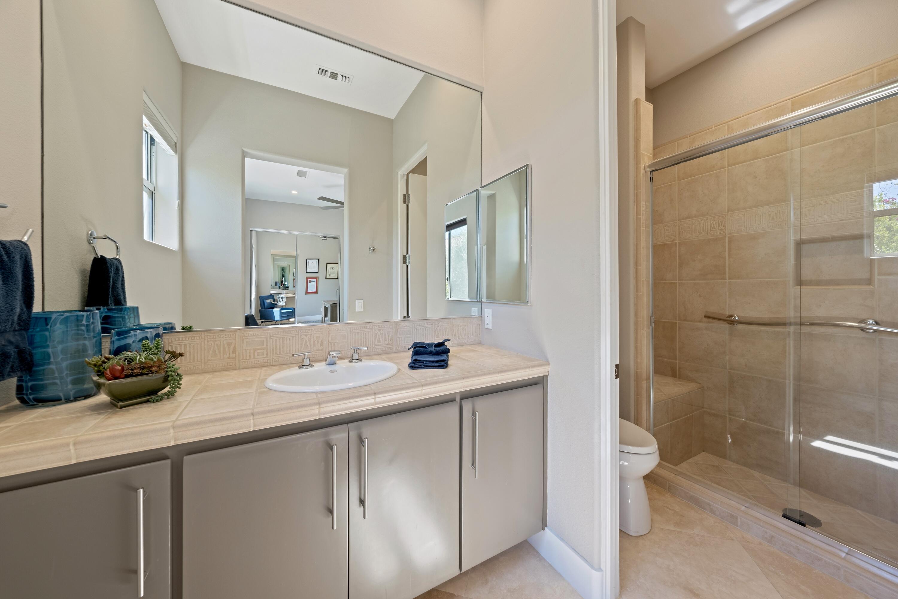 306 Loch Lomond Road Rancho Mirage, CA 92270 - Photo 33 of 60 a bathroom with a sink a toilet and shower