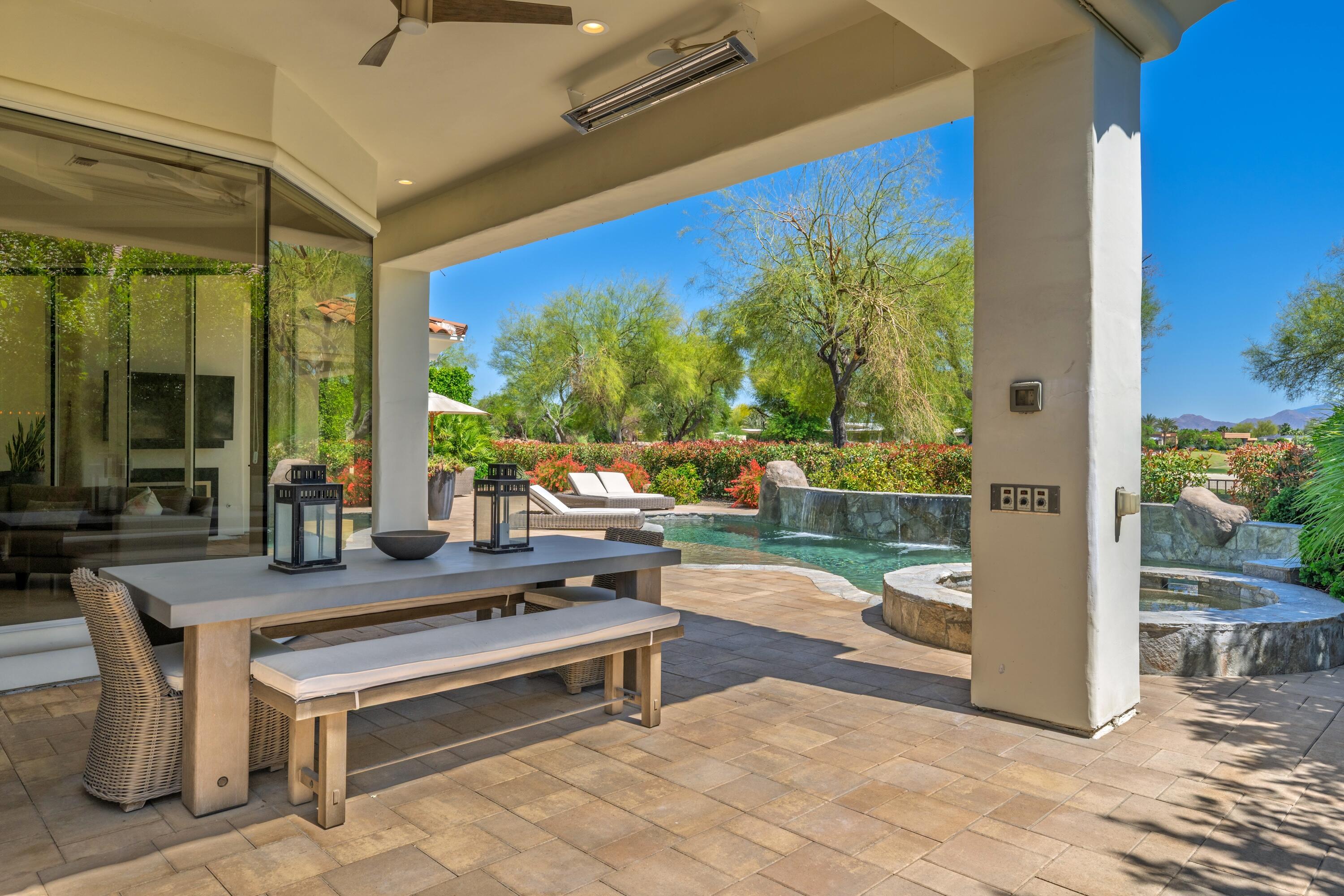 306 Loch Lomond Road Rancho Mirage, CA 92270 - Photo 42 of 60 a living room with patio furniture and a floor to ceiling window
