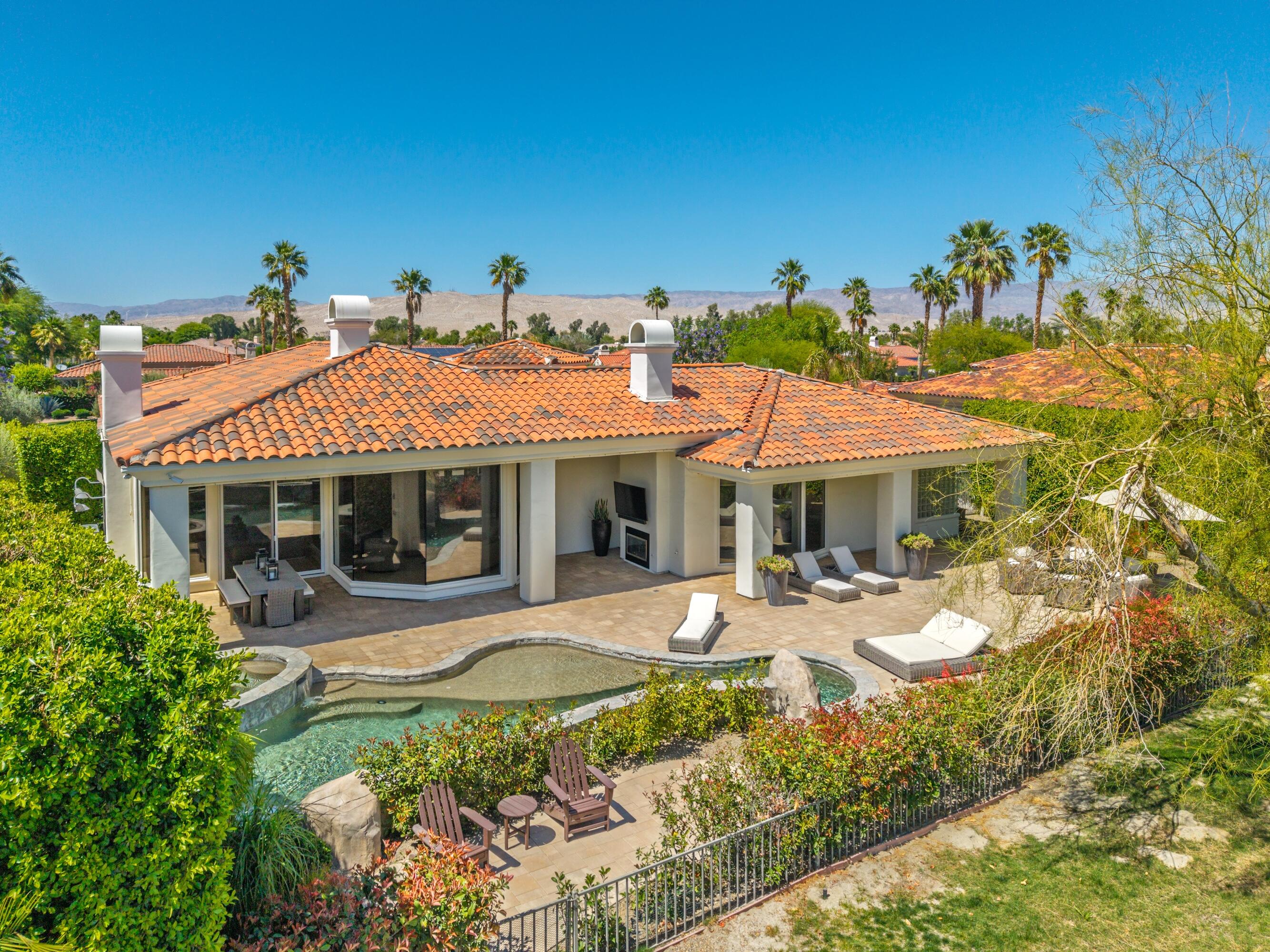 306 Loch Lomond Road Rancho Mirage, CA 92270 - Photo 59 of 60 a front view of a house with patio furniture and garden