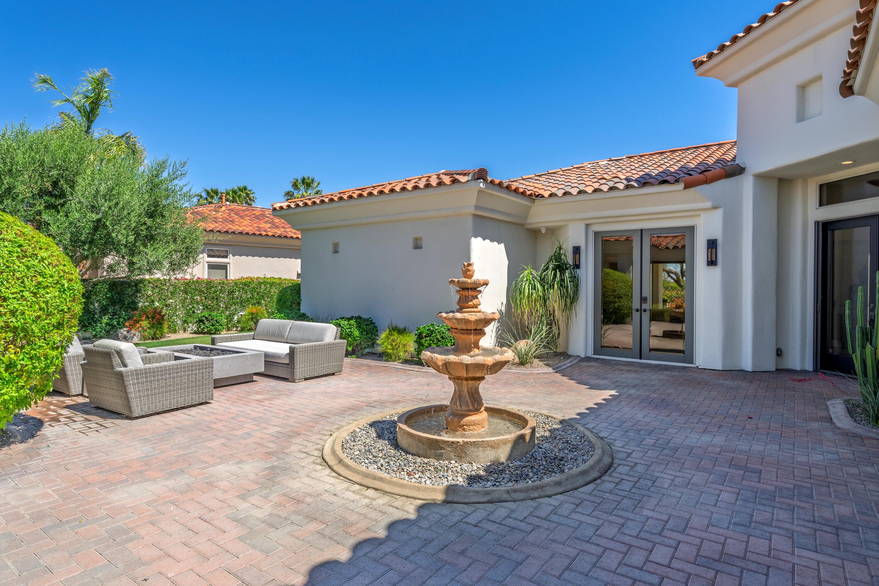 306 Loch Lomond Road Rancho Mirage, CA 92270 - Photo 6 of 60 a view of a patio with couches chairs and potted plants