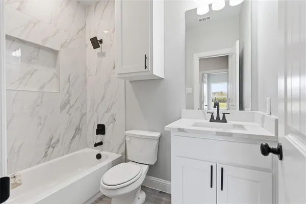 a bathroom with a sink a toilet and a mirror