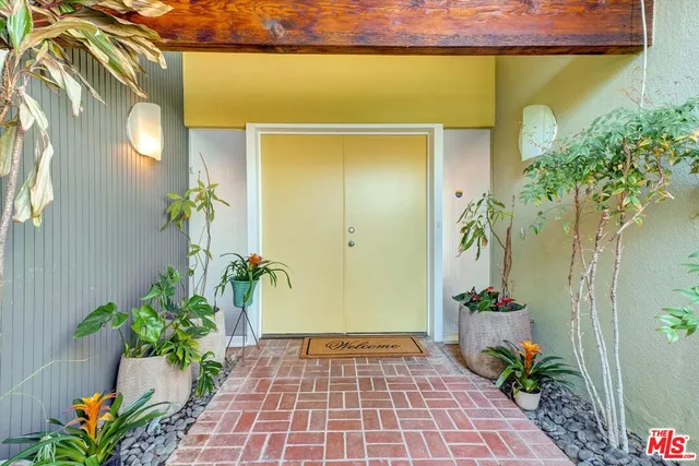 a view of empty room with wooden floor and fireplace