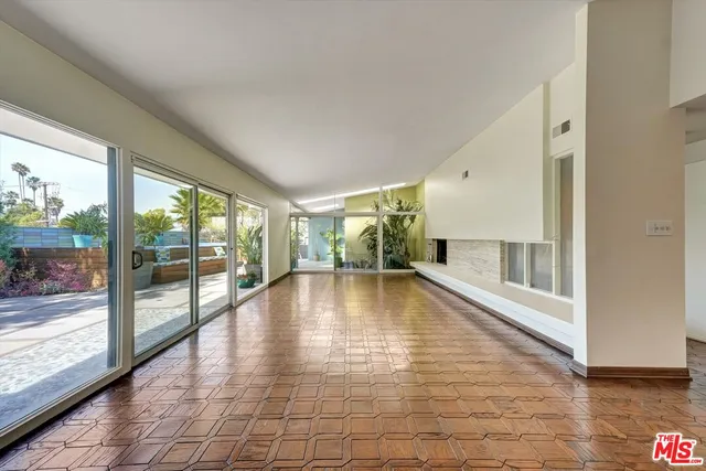 a view of a kitchen and an empty room and a kitchen