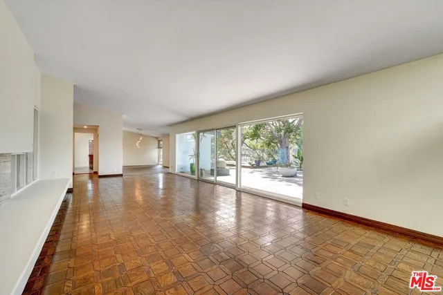 wooden floor in an empty room with a fireplace