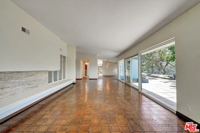 an empty room with large windows and painted walls