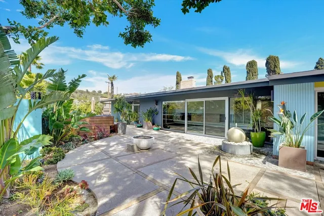 a view of a house with sitting area and garden
