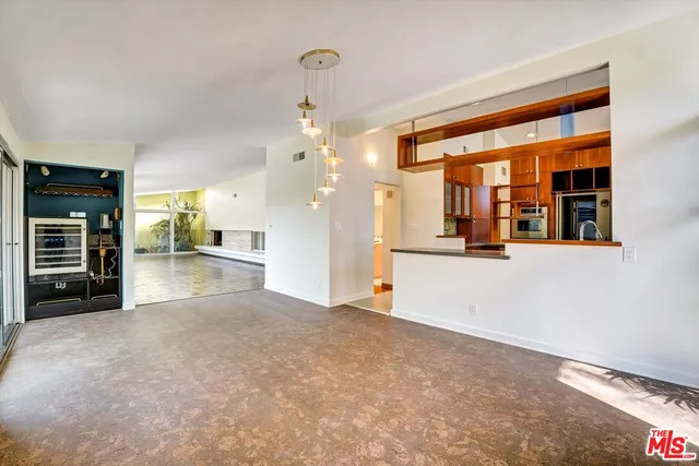 a kitchen with stainless steel appliances granite countertop a stove a sink and a wooden cabinets