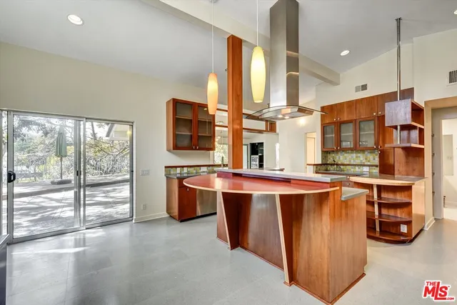an empty room with wooden floor and mirror
