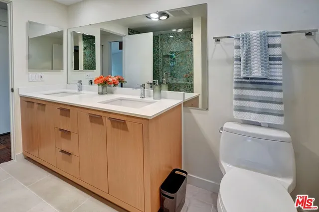 a view of an empty room with wooden floor and a large window