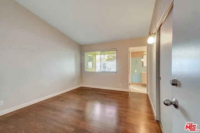 a bathroom with a granite countertop sink a mirror and shower