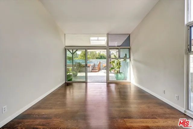 a view of a backyard with chair potted plants
