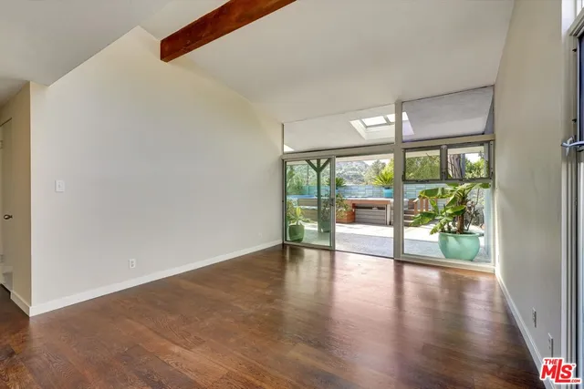 a room with patio furniture and a potted plant