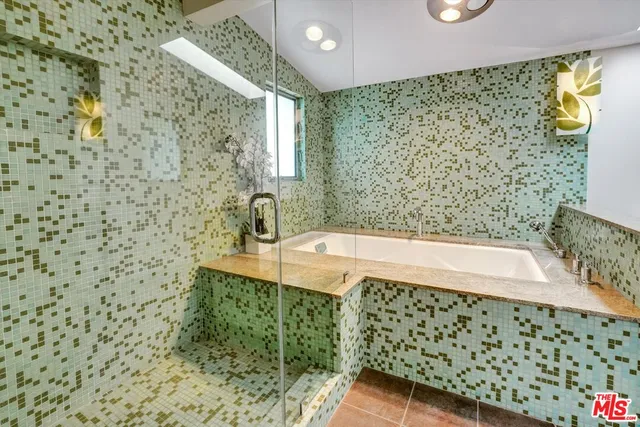 a view of a patio with table and chairs under an umbrella next to a yard