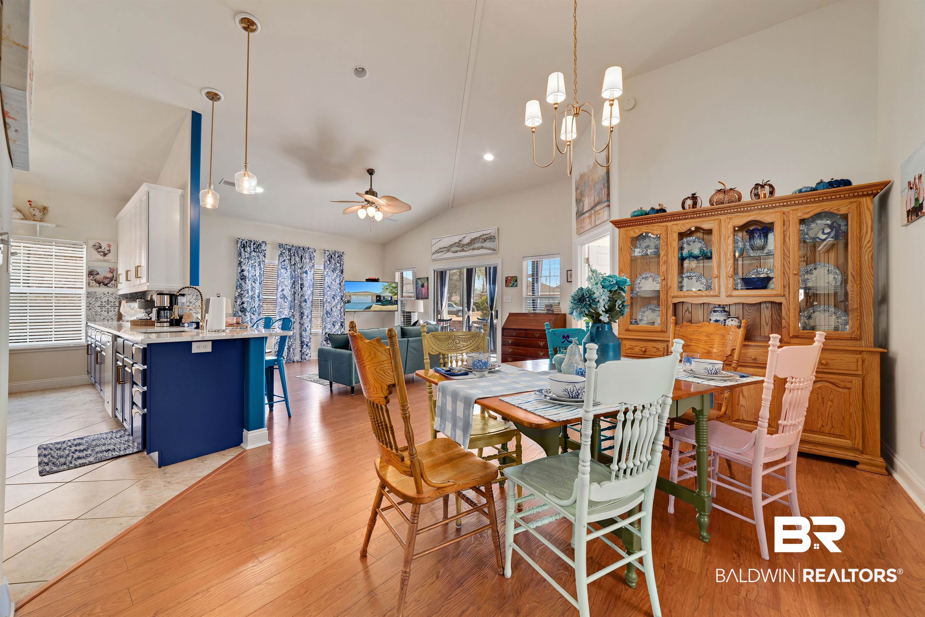 218 Hemingway Loop Foley, AL 36535 - Photo 2 of 39 Dining space featuring ceiling fan, light wood-style floors, high vaulted ceiling, and a chandelier
