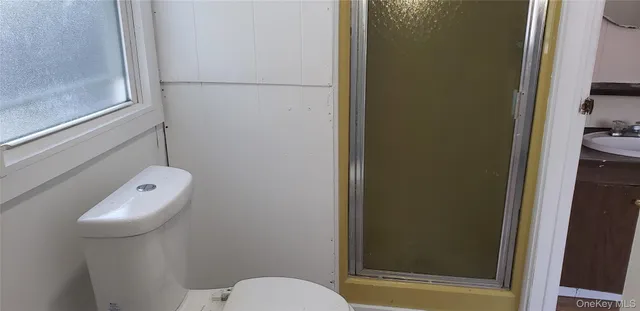 a bathroom with a toilet and a shower
