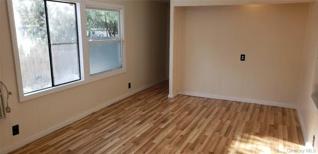 a view of a room with wooden floor and windows