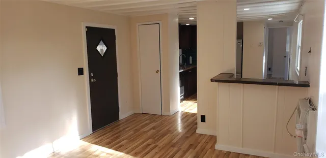 a view of hallway with wooden floor