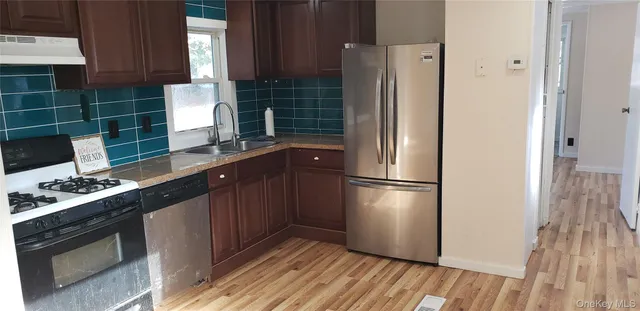 a kitchen with appliances a refrigerator and a stove
