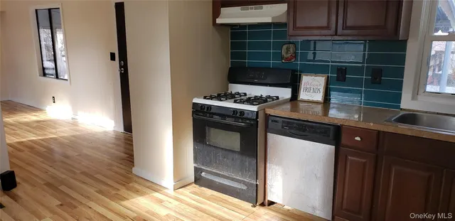 a kitchen with granite countertop a stove and a sink