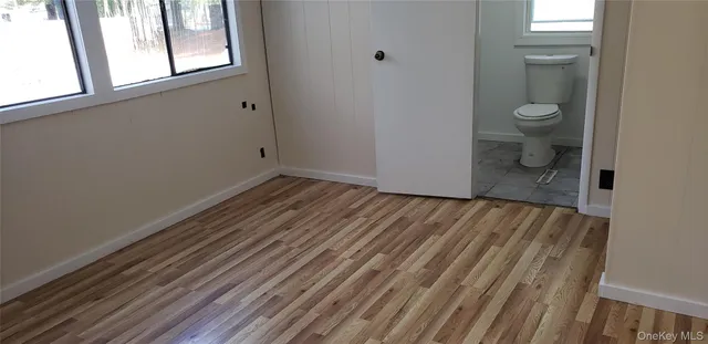 a view of a room with wooden floor and a sink