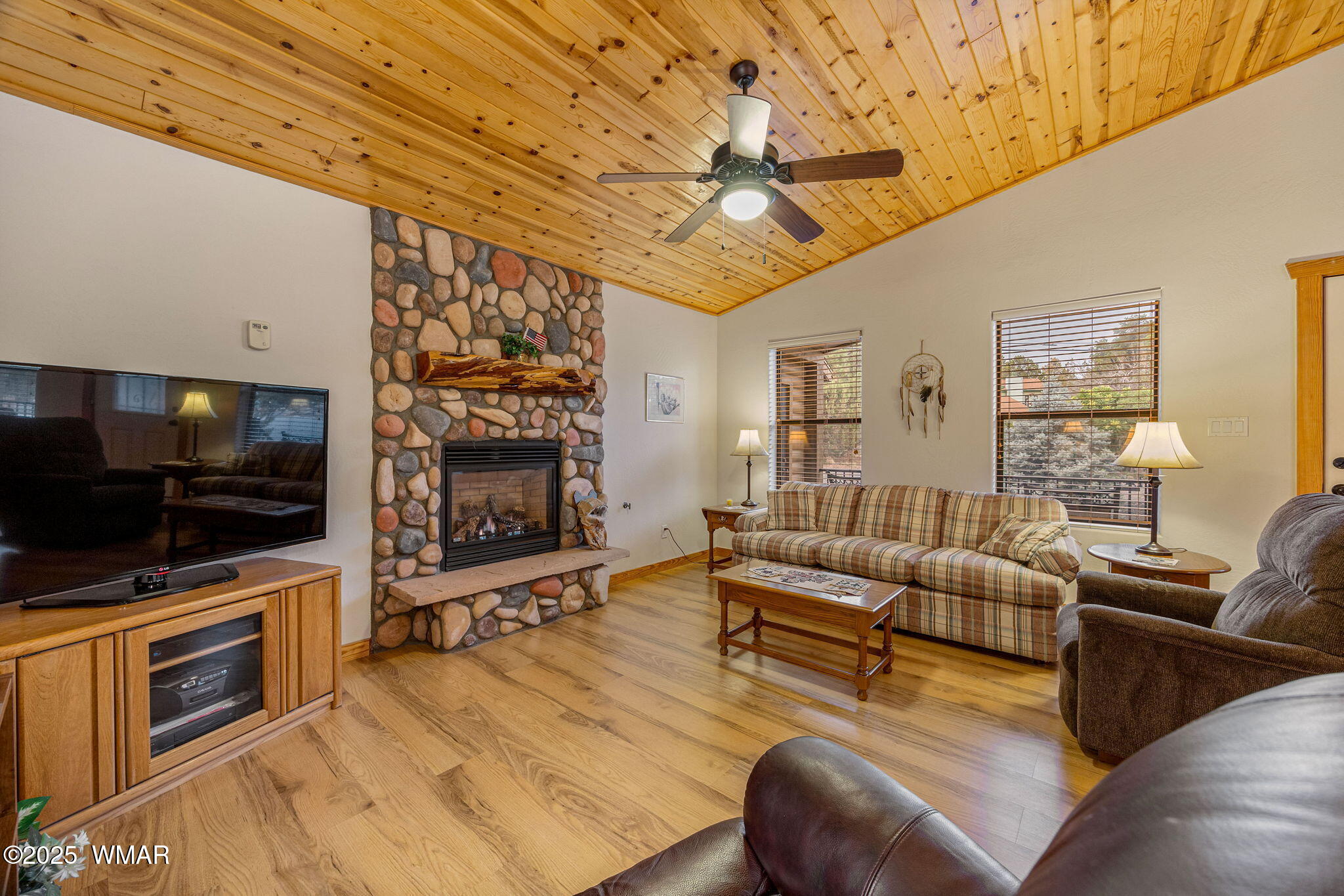 3142 Ranch Road Overgaard, AZ 85933 - Photo 11 of 35 a living room with furniture a flat screen tv and a fireplace