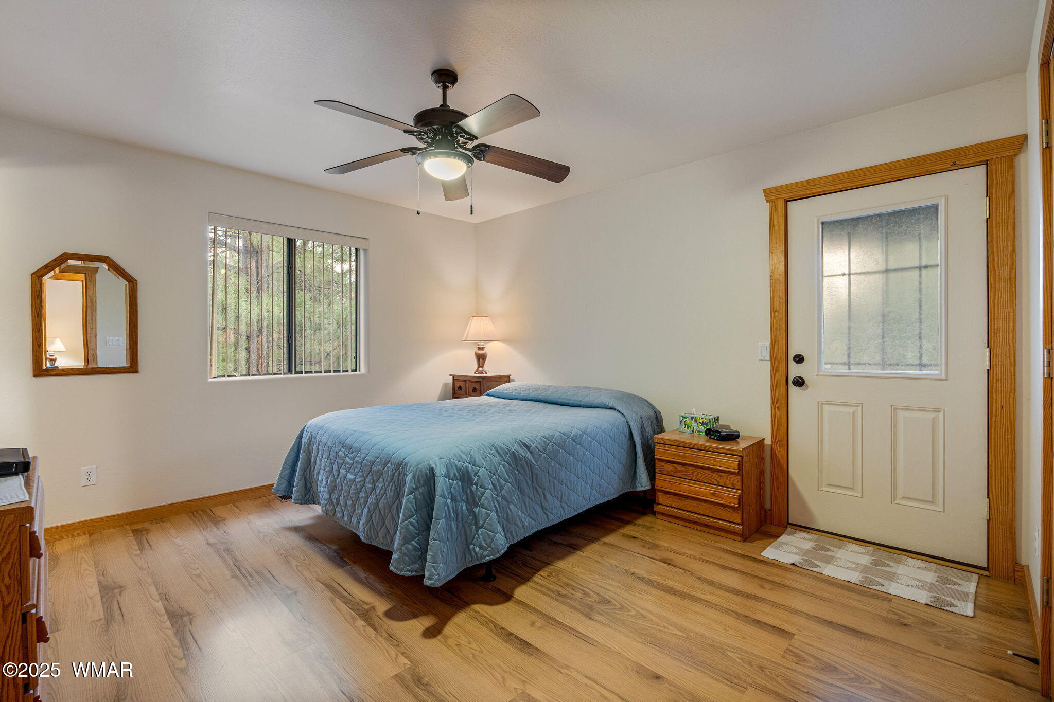 3142 Ranch Road Overgaard, AZ 85933 - Photo 15 of 35 a bedroom with a bed and a chandelier