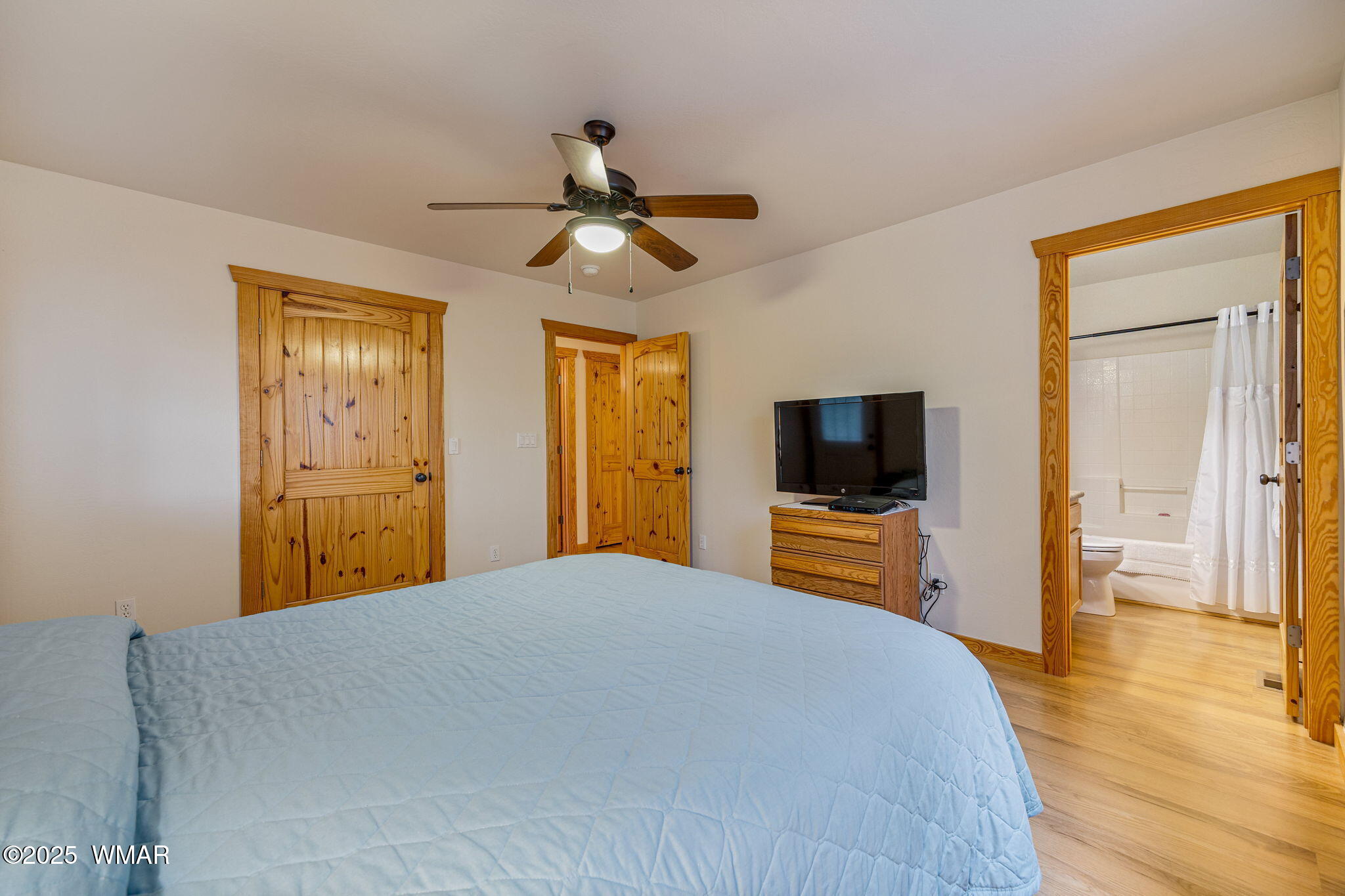 3142 Ranch Road Overgaard, AZ 85933 - Photo 16 of 35 a bedroom with a bed and wooden floor