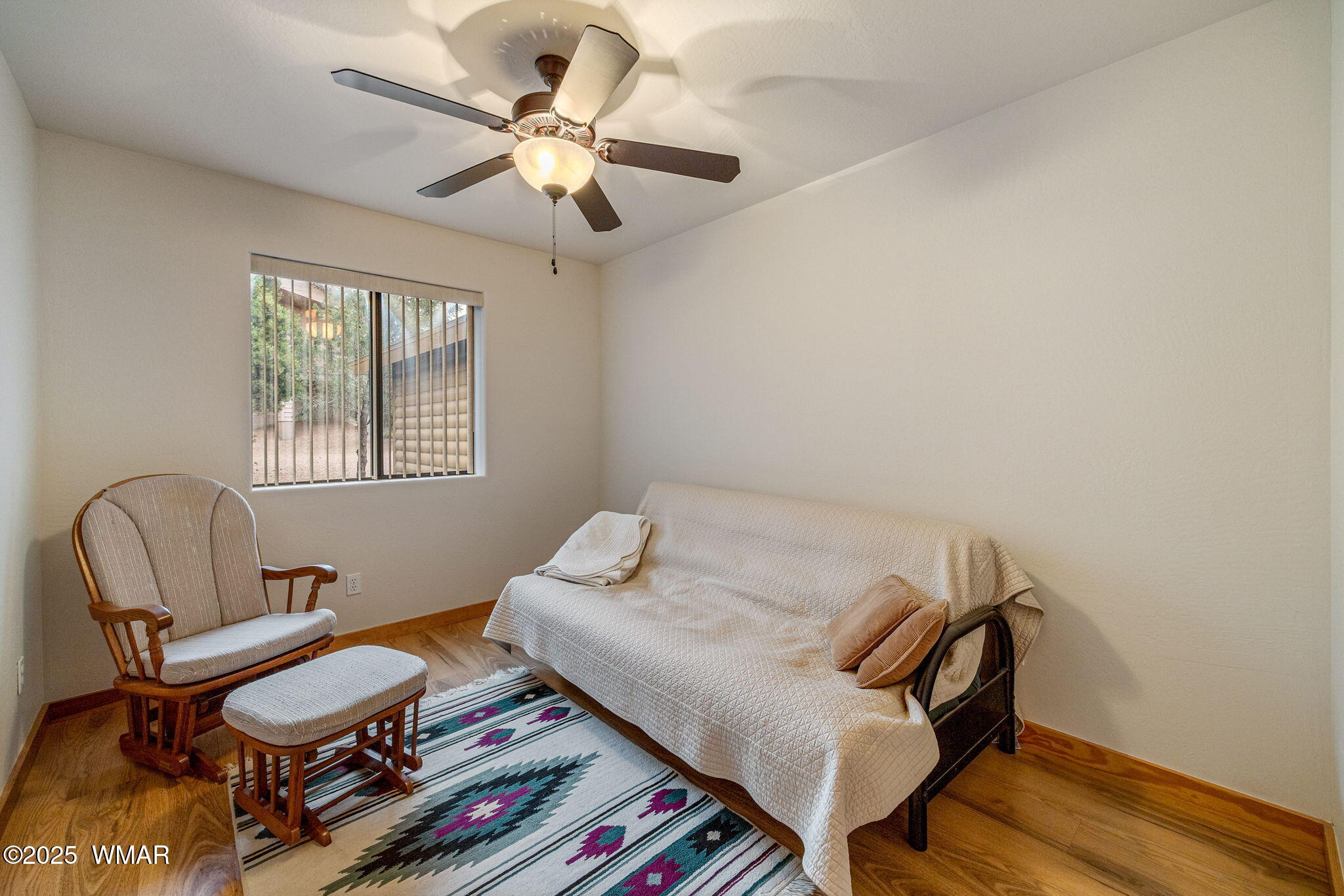 3142 Ranch Road Overgaard, AZ 85933 - Photo 20 of 35 a bedroom with a bed and a chair