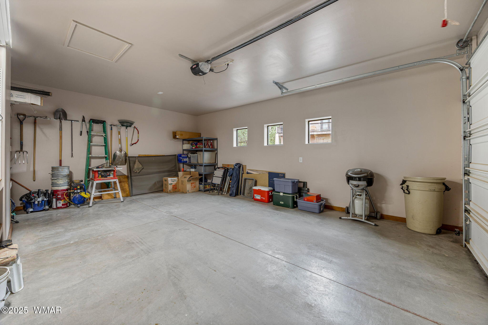 3142 Ranch Road Overgaard, AZ 85933 - Photo 21 of 35 a view of a garage with a large window and furniture