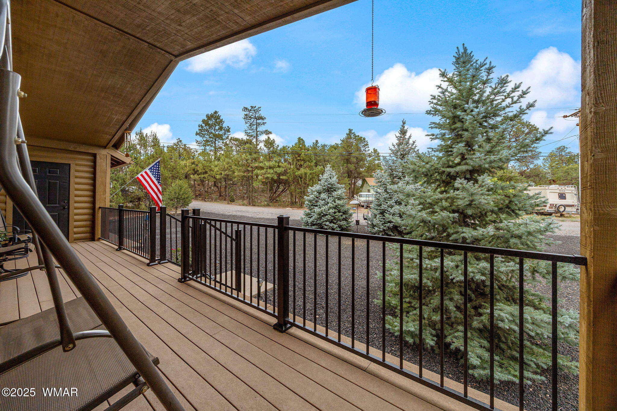 3142 Ranch Road Overgaard, AZ 85933 - Photo 5 of 35 a balcony with wooden floor and potted plants