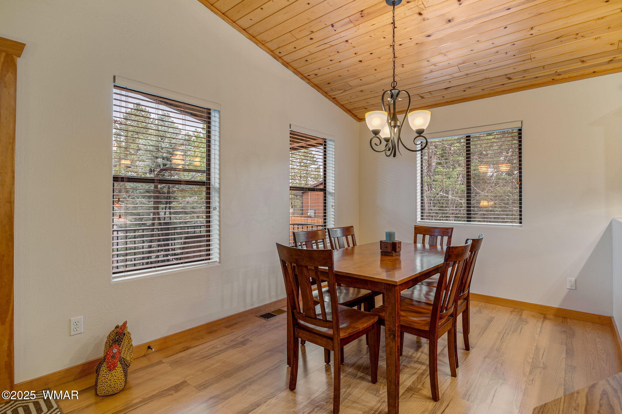 3142 Ranch Road Overgaard, AZ 85933 - Photo 10 of 35 a dining room with furniture a chandelier and wooden floor