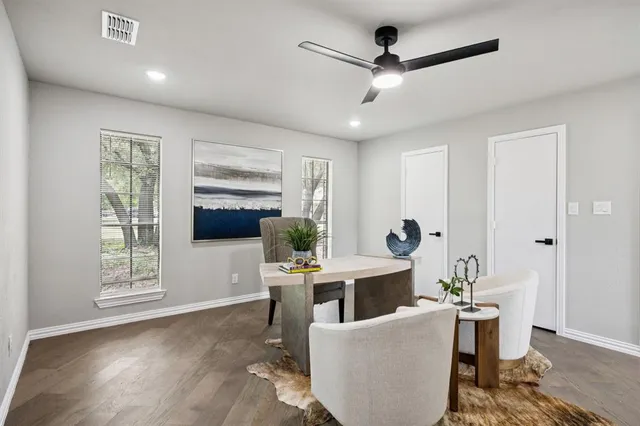 a living room with furniture a window and a ceiling fan