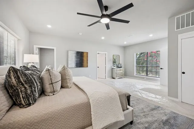 a spacious bedroom with a large bed and a window